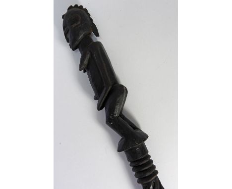 A carved wooden dogon hogon stick from Mali, 114cm long and a Tanga marriage stick from Tanzania, 117cm long (2)