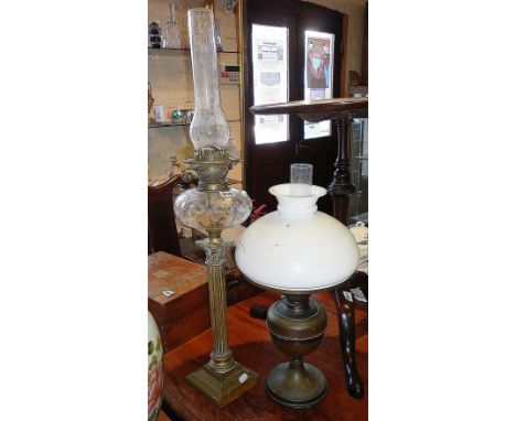 Tall Victorian brass column oil lamp with cut clear glass reservoir and another lamp