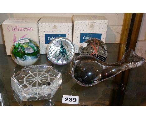Three Caithness glass paperweights with boxes, together with an Art glass whale and Kosta crystal paperweight