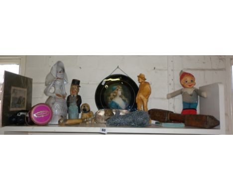 Shelf of assorted items including humorous painted carved figure etc.