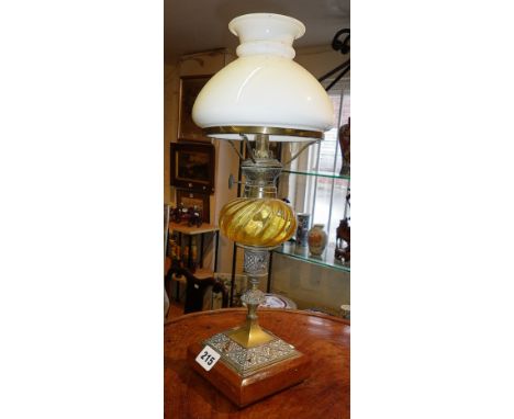 Small Arts &amp; Crafts brass oil lamp with glass reservoir above brass column having copper filigree decoration
