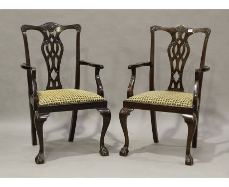 A set of seven early 20th century George III style mahogany pierced and carved splat back dining chairs, comprising two carve
