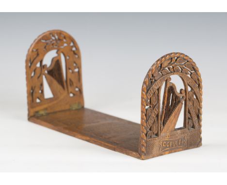 A late 19th century Irish carved oak extending bookstand, each end finely carved with a harp and inscription, length 31cm (so