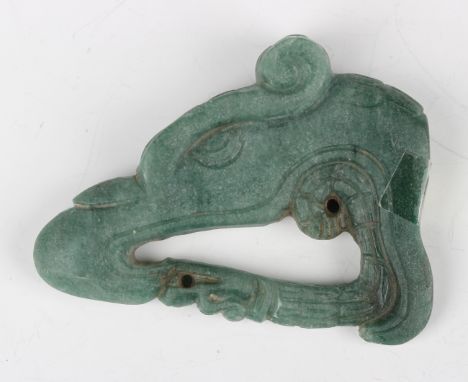 A pre-Columbian Mayan style green hardstone carving, probably 400-800 AD, modelled as the head of a beast devouring a reptile