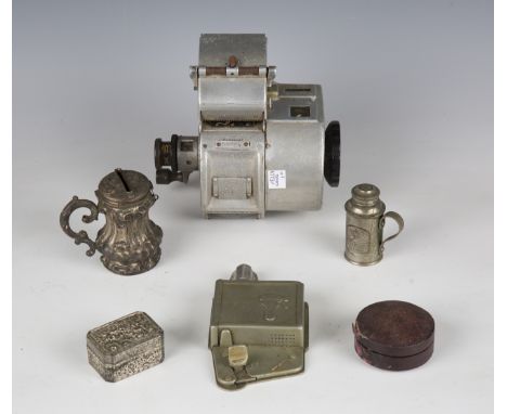 A small group of collectors' items, including a bus ticket machine and punch, a surgeon's sterilising bottle, a money box tan