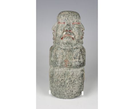 A pre-Columbian Olmec style carved green hardstone celt axe head, probably 900-450 BC, one end carved with three heads, beari
