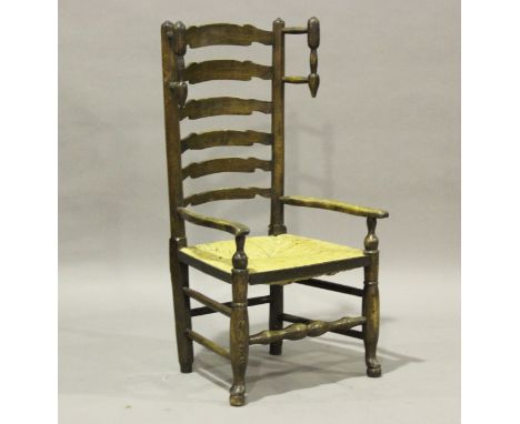 A 19th century provincial ash ladder back armchair, fitted with unusual headrests, height 101cm, width 55cm.Buyer’s Premium 2