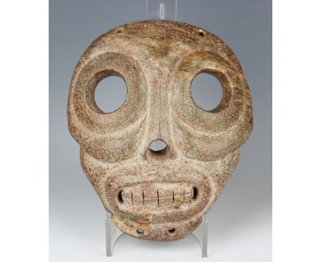 A large carved greenish-brown hardstone mask, probably Mexican, possibly 1600-1700 AD, height 22cm, width 18cm. Provenance: f