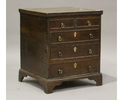 A George III and later provincial oak commode chest, fitted with a hinged lid enclosing a well above two drawers, height 59cm