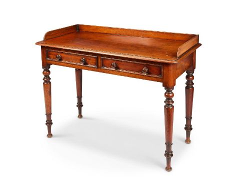 An early Victorian mahogany dressing table
The rectangular moulded top with three-quarter gallery above two frieze drawers on