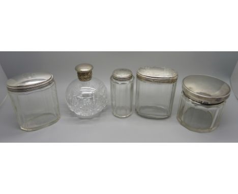 Four vintage silver topped jars and a cut glass perfume bottle 