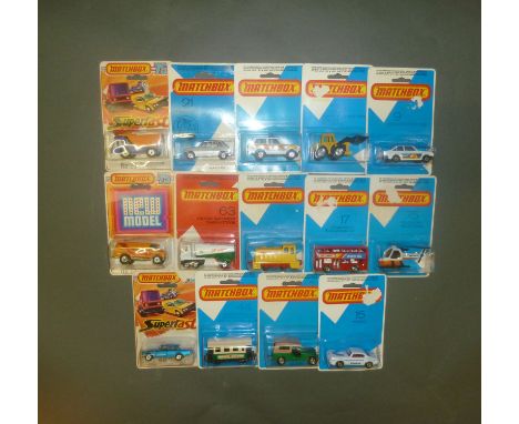 A collection of 14 Matchbox models in blister packs : Shovel nose tractor (29), Ford Escort RS2000 (9), Police petrol car (20