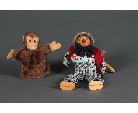 A Berg monkey hand puppet and a clown puppet