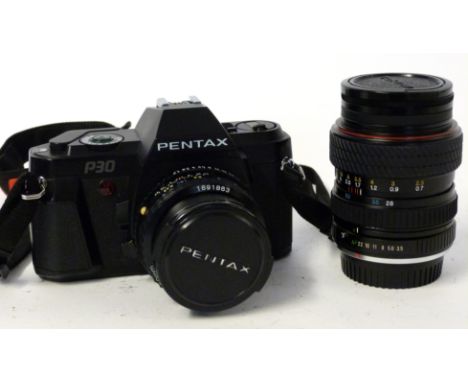 Pentax P30 film camera together with a Pentax-A 50mm lens + Tokina 28-70mm lens and manual