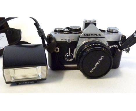 Olympus OM-2 film camera together with Zuiko 50mm lens with flash and case