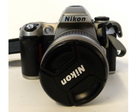 Nikon F80 film camera with film already loaded, together with Nikon AF Nikkor 28-100mm lens