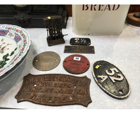 A small vertical engine and various cast iron name plaques