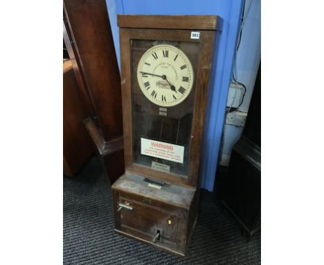 An oak cased time clock