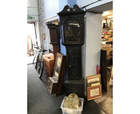 A carved oak long case clock and spares