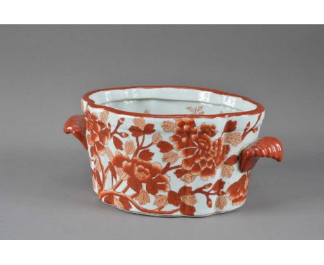 A Chinese twin handled ceramic export ware tureen,  red and white floral design to the exterior, fish to the inside, crazed, 