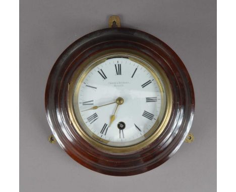 A Chavin & Bornand wall clock, white enamel dial with Roman Numerals, makers name, circular wooden body, the back of the move