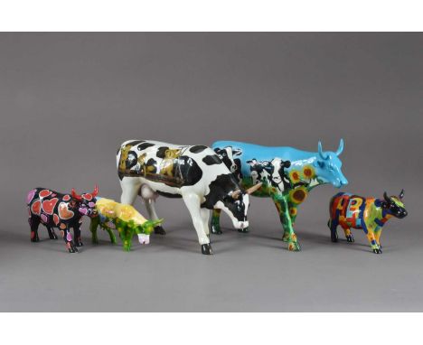 A collection of cow figurines, the two largest resin and unmarked, both approx. 18cm high, together with three 'Cow Parade' s