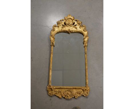 A decorative frame gilt painted mirror, in a classical French style, some wear, 101cm x 45cm
