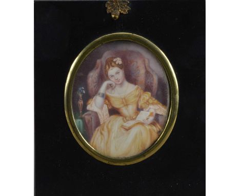 A 19th century Portrait miniature on ivory of a seated  young lady, oval in shape, in an ebonised frame with acorn loop mount