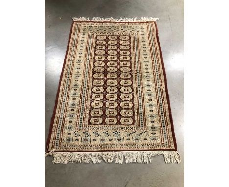 A woollen Persian rug, in the Tekke style, light colours with geometric pattern, 128cm x 182cm