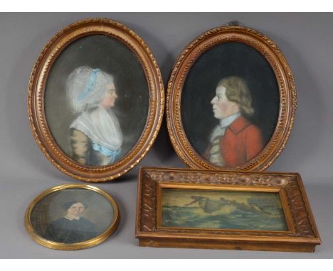 A pair of portraits of a man and a women, in oval frames,  both frames 31cm H, together with a smaller portrait and a fishing