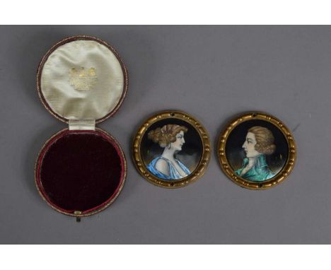 Two late 19th or early 20th century copper enamelled portrait miniatures, of a women and man in a green regency coat, both wi