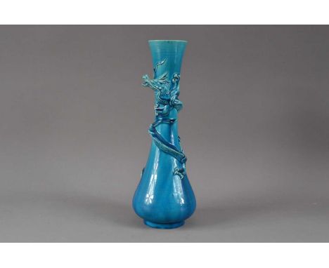 A blue glazed ceramic dragon vase, the raised dragon wound around the body, 31.5cm high