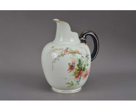 A 20th century Royal Worcester porcelain ewer, blue and gilt handle, the body with a floral design on a white ground, printed