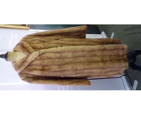 A ladies light brown fur coat with silk lining ++good condition