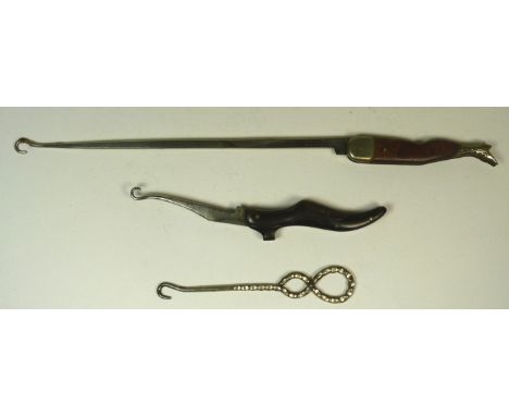 A Victorian novelty folding button hook the handle modelled as a ladies shoe; a German made folding button hook the short han