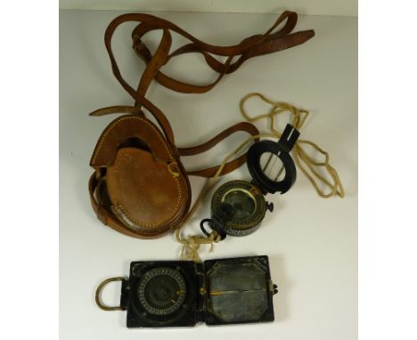 A WWII military marching compass MKIII dated 1944 in original brown leather case and together with another marching compass (
