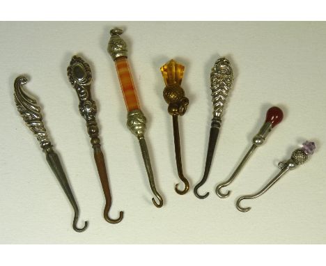 A group of seven small, decorative button hooks includes hardstone and agate handles (7)