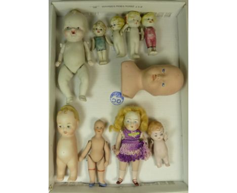 A quantity of small all bisque dolls and a head and shoulders bisque doll (no body)