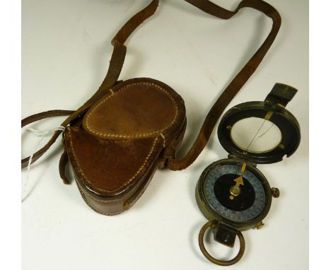 A WWI marching compass in brown leather case, the compass dated 1915 the case 1916