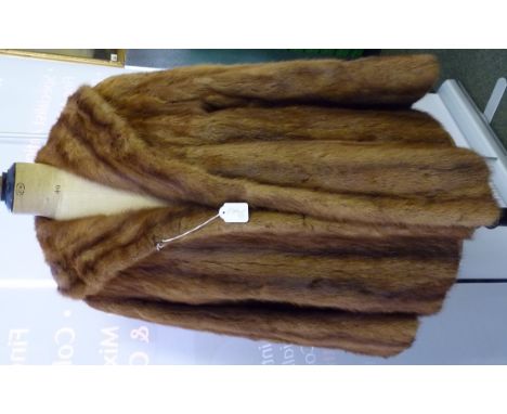 A ladies light brown fur jacket with silk lining ++with slight wear