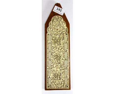 A superb 19th century Chinese carved ivory cribbage board, mounted later onto a hardwood back, ivory length 24cm