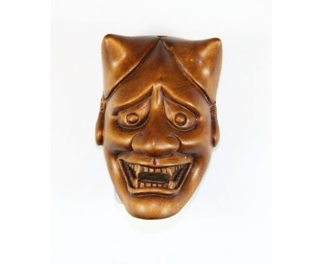 An unusual Devil mask carved fruitwood netsuke