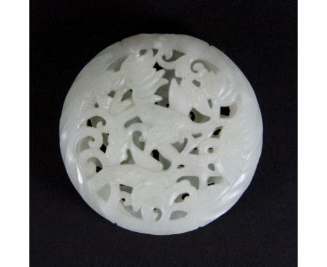 A fine Chinese white jade double pierced hollow amulet or fragrant spice holder decorated with a dragon and foliage, Dia 5.5c