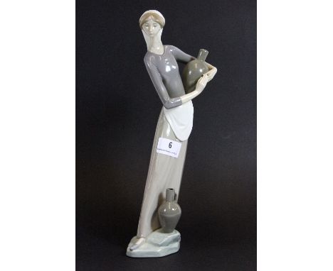A Lladro figure of a girl carrying water, H 32cm
