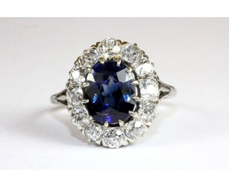 A lovely white metal (tested 18ct gold) sapphire and diamond cluster ring (N)