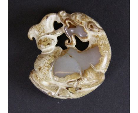A Chinese carved white jade dragon amulet, Dia 5cm
