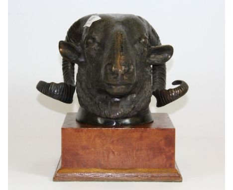 A bronze rams head fitted for wall mounting but with a wooden pedestal, Head H 15cm