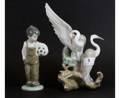 A Nao figure of 2 cranes and a Nao figure of a boy with a football