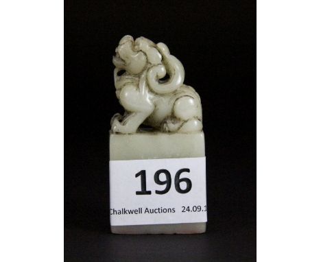 A Chinese carved celadon coloured hardstone seal c. 1920 mounted with a dragon, H 6cm