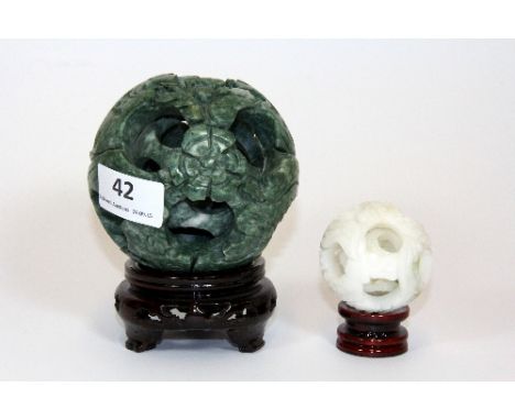 A Chinese carved jade/hardstone concentric puzzle ball (Dia 10cm) together with a further ball (5.5cm)